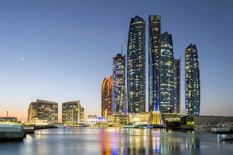 Abu Dhabi Skyline Etihad Towers skyscrapers at night in Abu Dhabi, United Arab Emirates