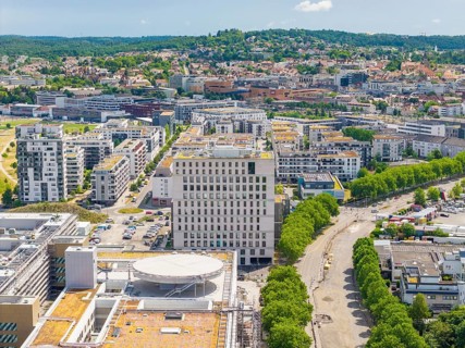 View of a modern district with high-rise buildings, green roofs and surrounding vegetation, new
