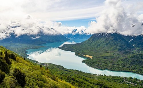 View of snowy mountains in spring and turquoise blue Kenai Lake, Slaughter Ridge Trail, Cooper