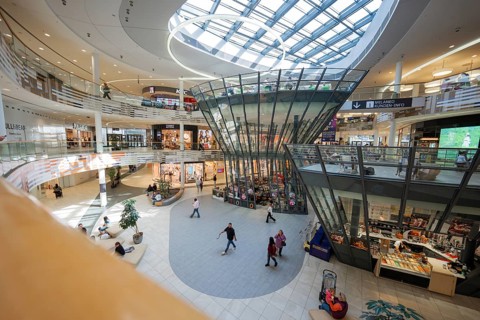 Modern shopping center with large glass roof and bustling atmosphere, Milaneo, Stuttgart, Germany