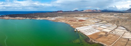 Salt mining plant, Salinas de Janubio with green Laguna de Janubio, near Yaiza, aerial view,