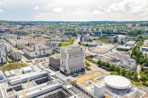 City view from above with modern buildings, roads and a clear sky on the horizon, new hospital