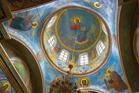 Interior view of a church ceiling with colorful frescoes and images of Christ, Hîncu monastery,