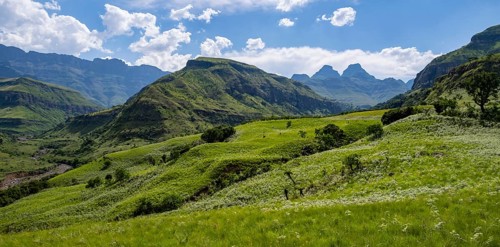 Mountainous landscape of the Cathedral Range mountains and green mountain valley, Drakensberg