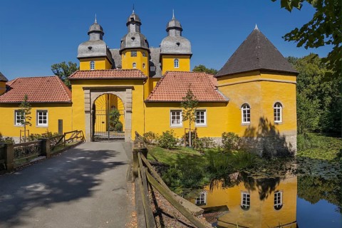 Holter Castle with moat in summer in Holte-Stukenbrock Castle, North Rhine-Westphalia, Germany