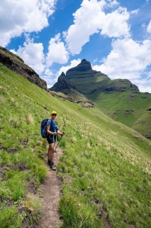 Female hiker on the hiking trail to Cathedral Peak, Green Mountains and Hills, Drakensberg