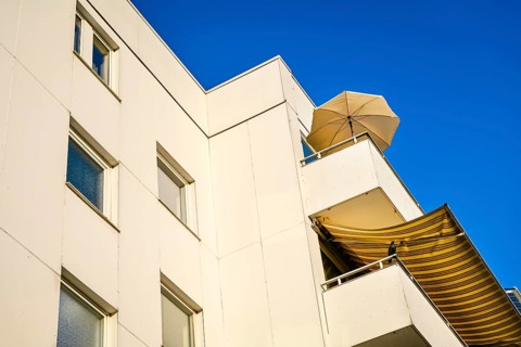 Balconies with parasol and awning in Scharbeutz, Schleswig-Holstein, Germany +++ editorial use only