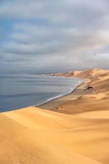 Sand dunes and sea, Atlantic coast and sandy desert with sea of dunes, Sandwich Harbour, Namib