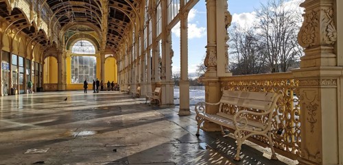 Quiet historic arcades with a bench that stands in the sun. Elegant railing, Maxim Gorky Kollonade,