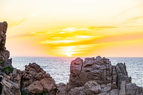 Landscape of the coastline with blue water at Costa Paradiso on a sunny day at sunset, Sardinia,