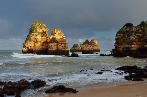 Rock formations on the coast in the evening light, Praia do Camilo, Lagos, Algarve, Portugal