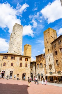 Towers of the old Town with historic buildings from Piazza della Cisterna at San Gimignano on a