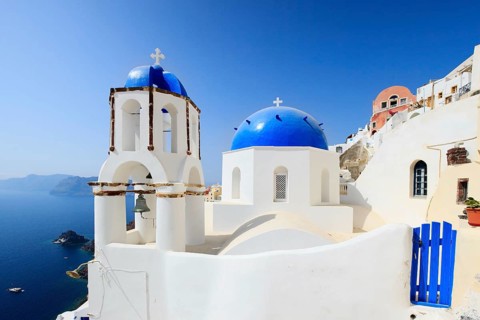 Classic Greek style church in the traditional white and blue village of Oia on Santorini, Greek