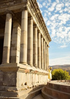 Young tourist woman taking picture in Armenia by Garni roman temple on summer vacation - Travel,