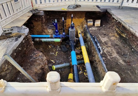 Secured construction site, underground supply lines in the standard colour codes blue for drinking
