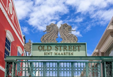 Colorful decorative Old Street Sint Maarten entrance gate with twin lion sculptures and ornate