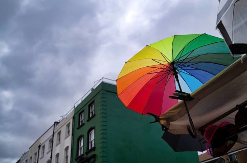 Market stand, coloured umbrella, rainbow colors, rain clouds, dark clouds, Portobello Road Market,