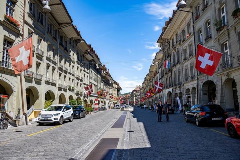 Kramgasse with historic houses decorated with cantonal flags and Swiss national flags, old town,