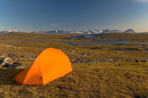 Tent in Stora Sjöfallet National Park, Laponia World Heritage Site, the Akka Massif on the horizon,