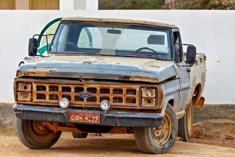 Old, rusted blue Ford truck in a rural setting, an old pickup truck on the road in Bahia Brazil