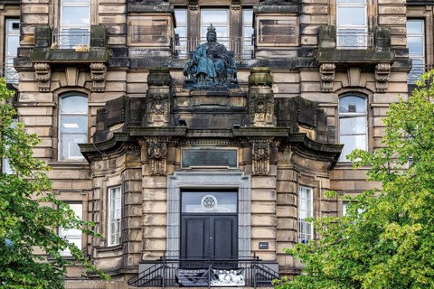 Ornate Edwardian facade of Glasgow Royal Infirmary Jubilee Block is topped by a bronze Queen