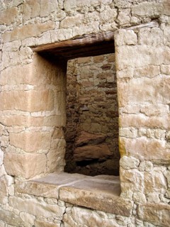 Rectangular wall opening, historic window in a rustic wall, wooden beams for stabilization, Cliff