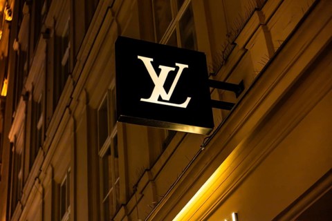 Vienna, Austria - 15 December, 2025: A Louis Vuitton store sign illuminated at night in Vienna,