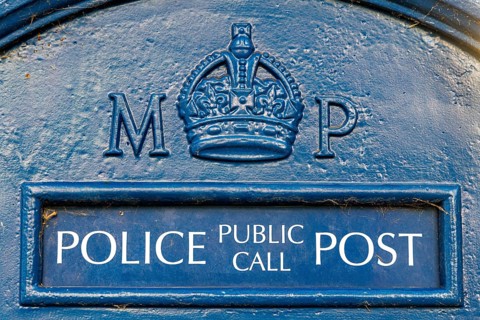 Historic Police Public Call Post stands near trees close to the former American Embassy in