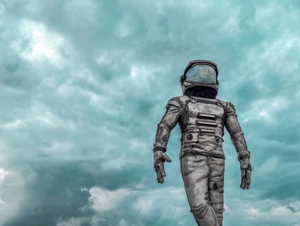 Antalya, Turkiye - 25.10.2025: An astronaut in a spacesuit walks on a barren landscape under a