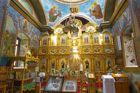 Magnificent interior of an Orthodox church with gold-decorated iconostasis and icons, Hîncu