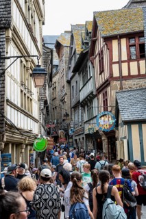 Mass tourism in the historic alleys of Rocky Island, Le Mont Saint Michel monastery island, tourist