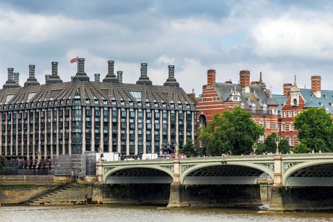 The modern glass and stone facade of Portcullis House, opened in 2001 as parliamentary offices,