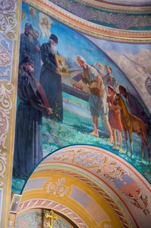 Religious fresco in a church depicting monks and saints in baroque style with bright colors,