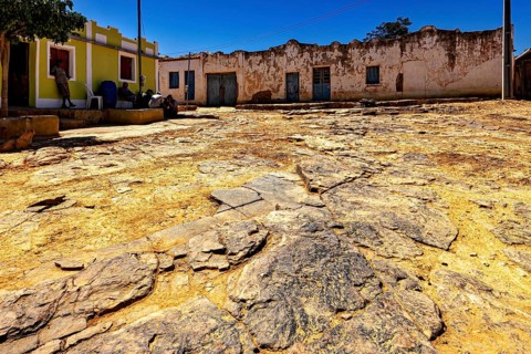 Old facades and rocky soil under blue sky, settlement and villages in the Caatinga of Pernambuco
