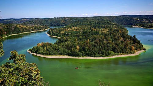 View from Heinrichstein rock massif viewpoint, of an island covered by forests in a curved river,