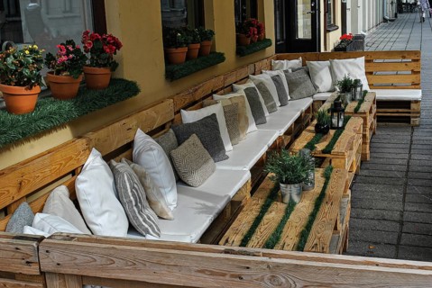 Summer Terrace Cafe with pillows and wooden pallets, outside restaurant terrace, Cozy outdoor