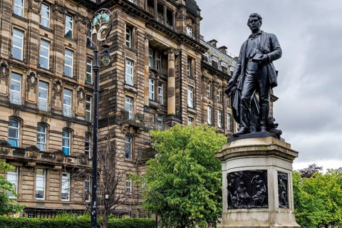 Statue of missionary explorer David Livingstone stands near the Glasgow Royal Infirmary building,