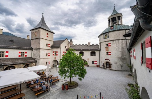 Castle courtyard building with beer garden and clock tower, Hohenwerfen Fortress, Werfen, Pongau,