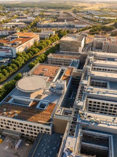 Extensive industrial architecture with detailed roof structures and roads, construction site of the