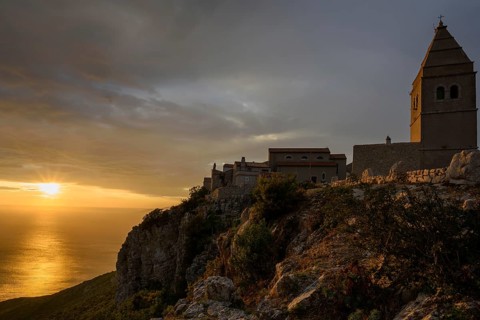 Sunset behind the village of Lubenice with castle, Croatia, Europe, Lubenice