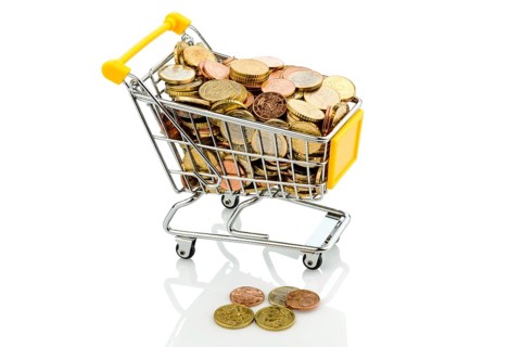 A shopping cart is well filled with euro coins, symbolic photo of purchasing power and consumption,