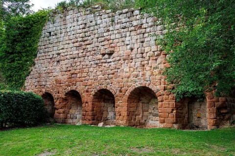 The ruined sandstone wall and arched vaults of the 14th-century Rosslyn Castle stand in Roslin,