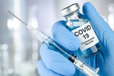 Healthcare Cure Concept with a Hand in Blue Medical Gloves Holding Coronavirus, Covid-19 Virus,