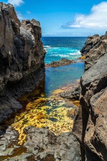 Volcanic rock formations surround charco azul. A stunning natural pool on el hierro island