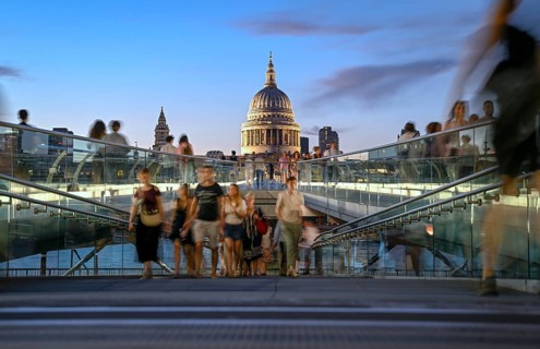 Evening scene on the Millennium Bridge over the Thames, blue hour, in the background St Paul's