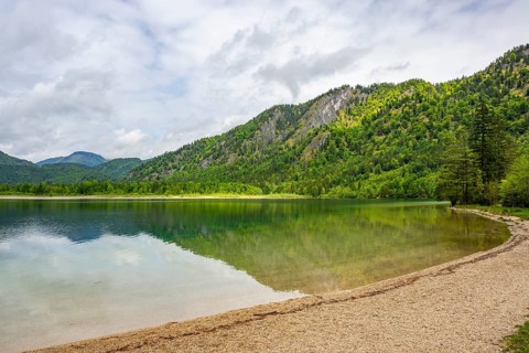 Landscape of Lake Offensee after rain when the sun comes through the clouds in spring,