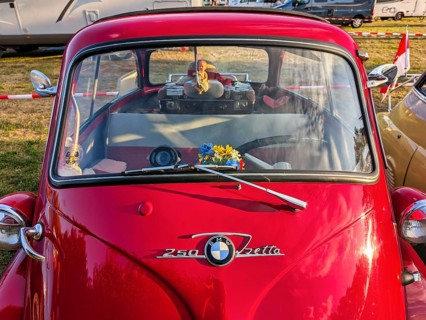 BMW Isetta, annual meeting 2026, distinctive red small car with front door, decorated, cult,