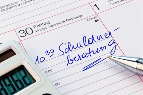 Date for debt counseling entered in a calendar. Symbolic photo of poverty and private bankruptcy,