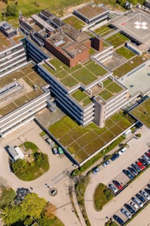 Roof view of a large hospital complex with lots of parking spaces and surrounding trees, Nagold