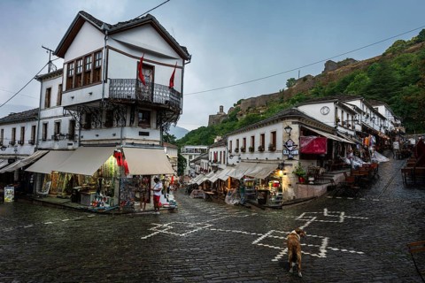GJIROKASTER, ALBANIA - JUNE 30, 2026: Traditional Albanian street in Gjirokastër during rainy day